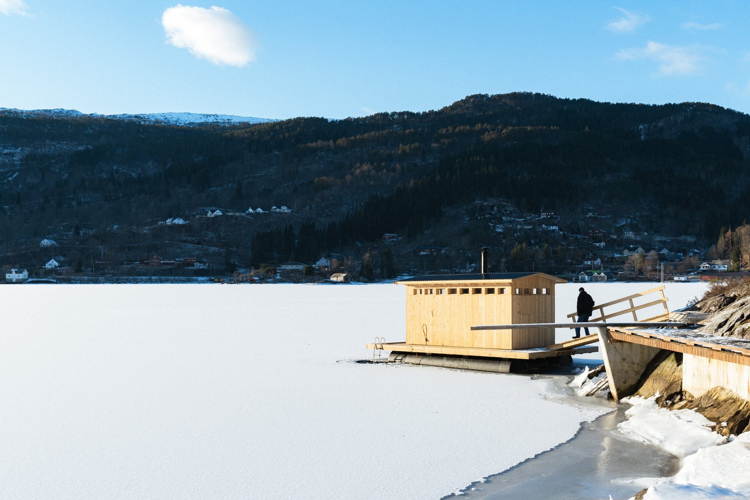 Bjørkheim Sauna ligg ute i den islagde Teigavika, med skog og fjell bak